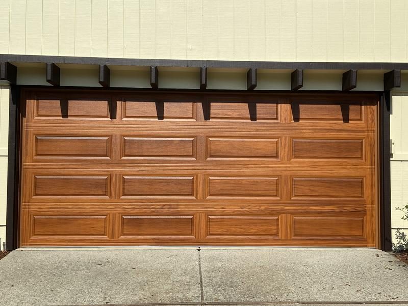 Wood raised-panel garage door with corbels
